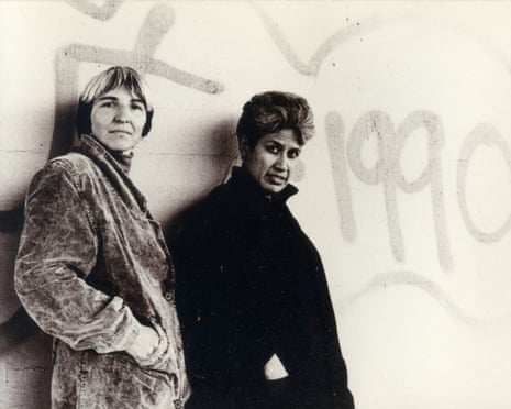 Norma Tanega and Aida Pavletich stand together against a graffiti-marked wall