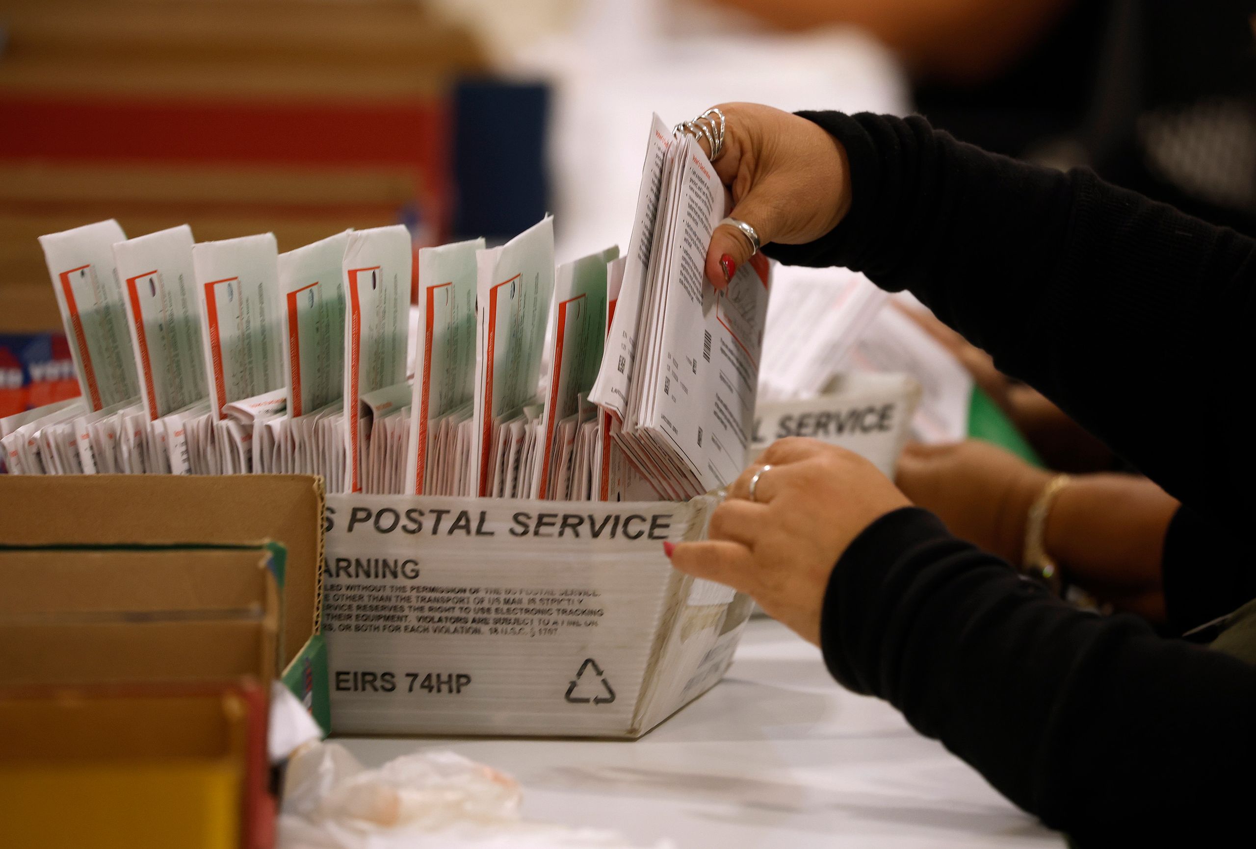 Hands sorting through mail.