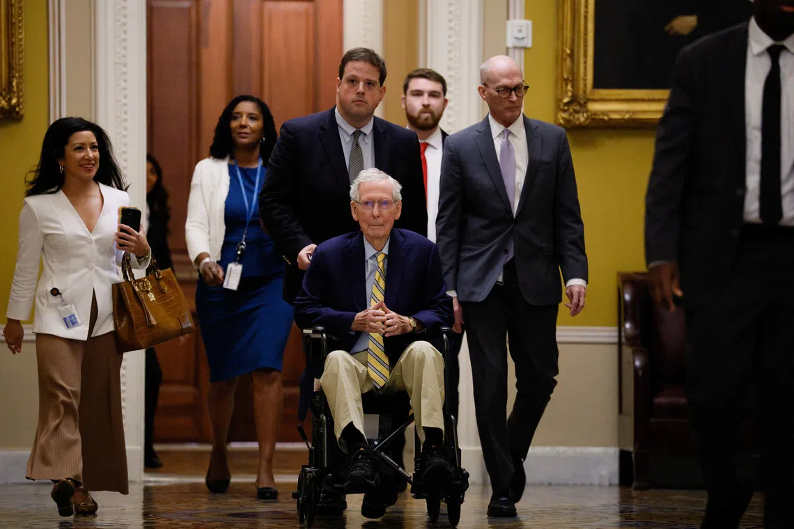 Senator Mitch McConnell (in wheelchair) arrives at the US Capitol on Sept 14.