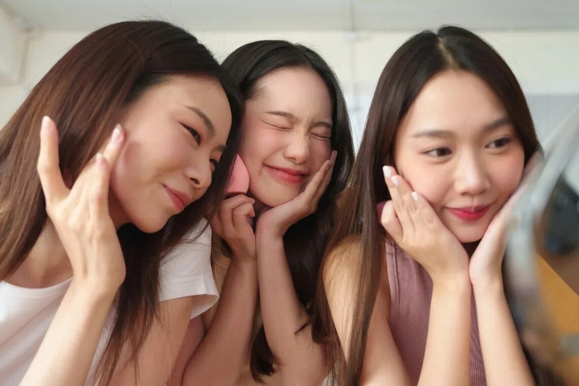 Three girls bonding over makeup and skincare